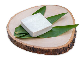 Tofu or soybean curd on wooden plate isolate on white with clipping path, Tofu or soybean curd  with fresh bamboo leaves.