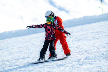 Snowboard School. Boy with Instructor Learning Snowboarding. - obrazy, fototapety, plakaty