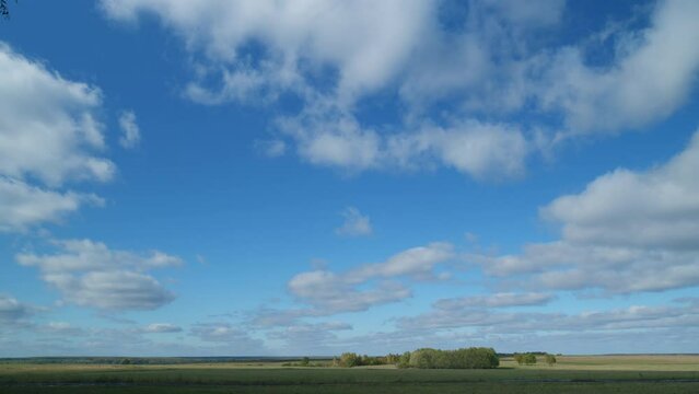 Countryside. Rural autumn landscape with a field. Blue sky in the background. Timelapse.