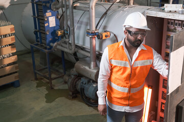 South Asia male factory worker or Man engineer or expert staff is maintenance and checking control system