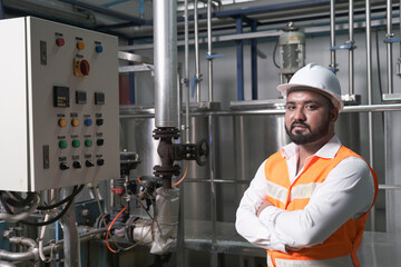 South Asia male factory worker or Man engineer or expert staff is maintenance and checking control system