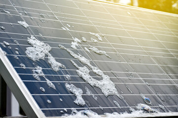 Closeup photovoltaic panel which had waterdrops and sponges on the surface, soft and selective...