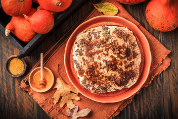 Homemade pumpkin cake with apples and fresh cheese icing