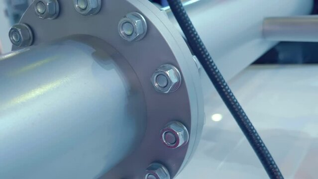 Flange connection of the blue pipeline with bolts. Shot in motion. Closeup