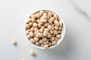 Top view of uncooked chick pea beans in bowl vegan food