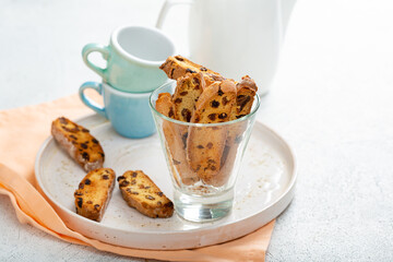 Close up of sweet cantuccini almond biscuits on plate copy space coffee cups on light surface