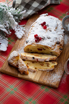 Sliced Christmas stollen with raisin and cranberry on festive table
