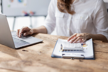 Business woman using calculator for do math finance on desk in Home office, Asian female finance business tax, accounting, statistics and analytic research concept