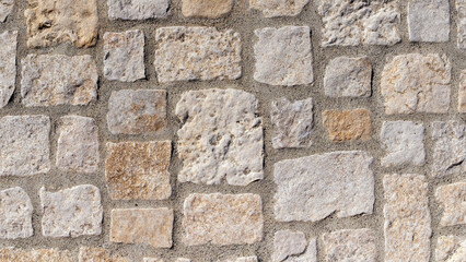 Background texture of newly laid stones in path with concrete joints
