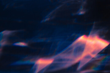 Blur colorful warm pink rainbow light leaks on black background. Defocused abstract analog retro film lens flare bokeh overlay or screen filter effect. Glow Vintage prism, water caustic, surreal light