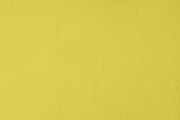 Saturated yellow colored low contrast Concrete textured background with roughness and irregularities. 2020, 2021 color trend.