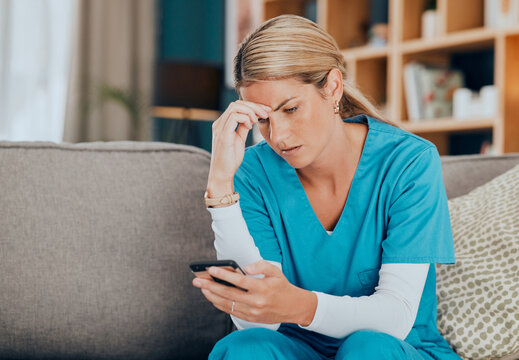 Phone, Healthcare And Worry With A Woman Nurse Reading A Text Message While Sitting On A Sofa In A Hospital Office. Mobile, Medicine And Medical With A Female Health Professional Receiving Bad News