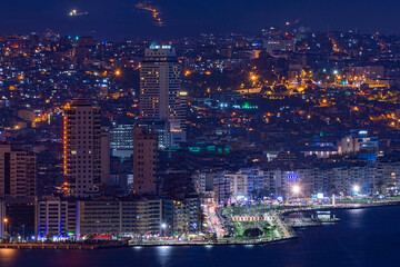 Fototapeta na wymiar Izmir, Turkey Night view from the sea of the new skyscrapers district of Izmir city. Izmir is Turkey's third largest city.