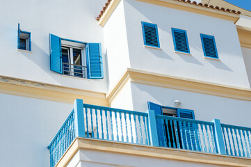 old Greek shutter window at a Greek village. Holiday vacation concept. Old Greek house with blue windows and door