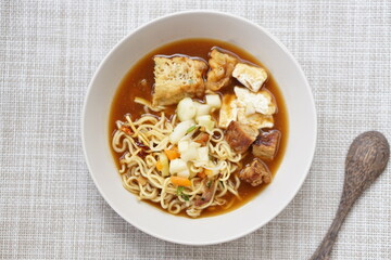 Tahu acar is traditional food from Solo, Middle Java Indonesia. Made from tofu pong and tempeh combined with pickled cucumber, wet yellow noodles, spicy sauce and other accompaniments.