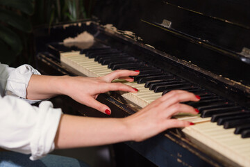 Fototapeta premium Woman hands on piano keys