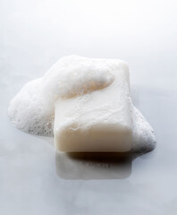 Solid soap placed against a marble background.