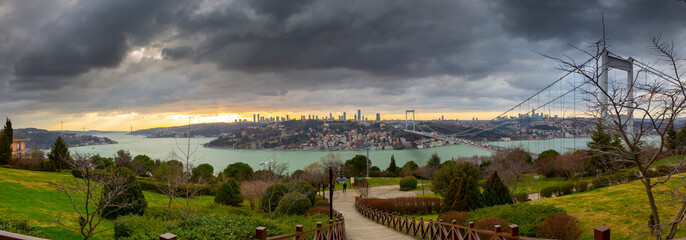 A panoramic view from Otagtepe to the Bosphorus at the sunset.Turkish flag and the FSM Bridge on...