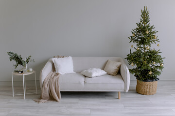 New Year's interior in the room. Festive Christmas tree. Cool stylish wall color. Minimalism in the house.
