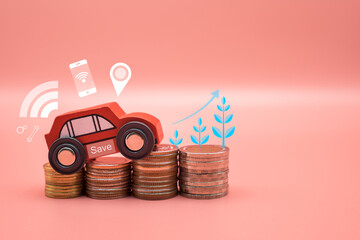 Red toy car on pile money stack coins growth on pink background. Miniature automobile model and business finance statement vehicle buy, loan, rent. Transportation insurance auto care industry concept.