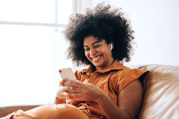 Business woman having a video call on a smartphone in an office - Powered by Adobe