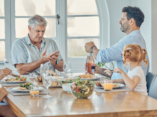 Lunch, dining room and family eating together in celebration at a modern home with food and champagne. Hurt grandfather in retirement, father and child enjoying a food meal at a dinner table at house