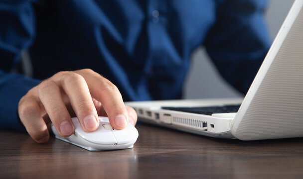 Male hand clicking computer mouse and typing in computer keyboard. Internet. Business. Technology