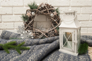 Winter background with plaid, lantern and Christmas wreath