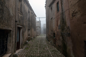 Fototapeta na wymiar Erice city street in morning fog, Sicily, Italy.