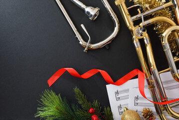 Trombone christmas music concert with decoration on black table