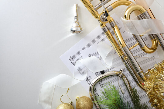 Trombone christmas music concert with decoration on white table
