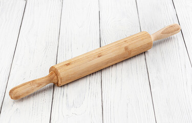 Rolling pin on white wooden background