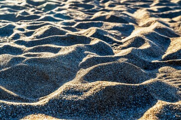 Shapes of sand in sunset on beach.