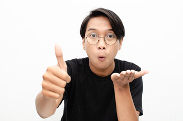 handsome attractive Asian man smiling happily and giving thumbs up as compliment isolated over...