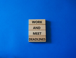 Work and deadline symbol. Concept words Work and meet deadlines on wooden blocks. Beautiful blue background. Business and Work and meet deadlines concept. Copy space.