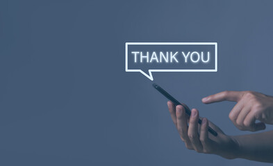 businessman touches the smartphone and sends message words to thank you.