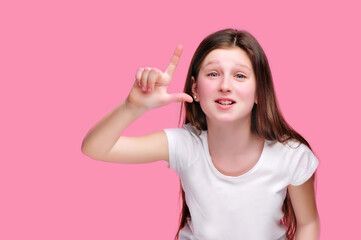 Funny girl showing looser gesture against pink background
