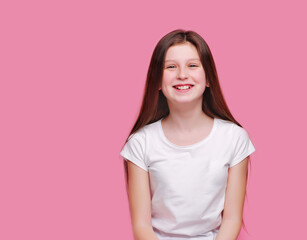 Happy laughing girl against pink background