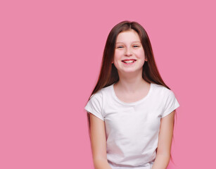 Obraz premium Happy laughing girl against pink background