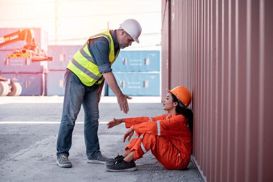 Industrial Engineer Worker Holding Hand By Encourage And Cheer Up After Hard Working At Container Dock Yard Transportation Import Or Export Site. Teamwork And Friendship Industry Workplace Concept