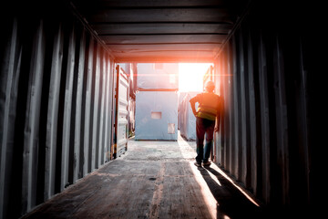 Engineers wearing safe uniform with working in the construction container dock yard checking and inspection containers data is container shipping Logistics business concept.