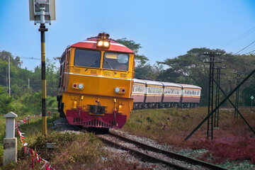 Obraz premium Passenger train by diesel locomotive passed the railway curve.