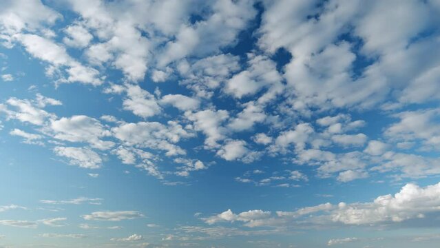 Cirrocumulus and cumulus on different layers cloudscape moved. Clearing day and good windy weather. Timelapse.