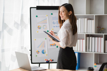 Beautiful Asian businesswoman standing confidently preparing for work.