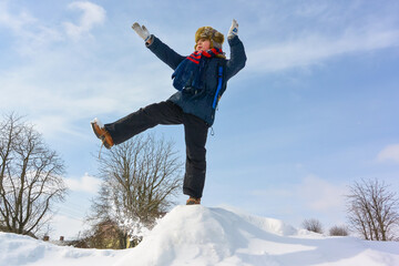 Happy boy jump outdoors. A boy plays outside in winter. Winter fun activity outdoor, winter vacation. Family time
