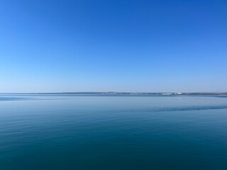 Blue sea horizon, clear blue sky and quiet sea surface