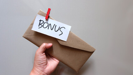 concept of bonus, communication by pulling paper of bonus from the envelope.