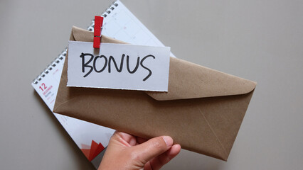 concept of bonus, communication by pulling paper of bonus from the envelope.