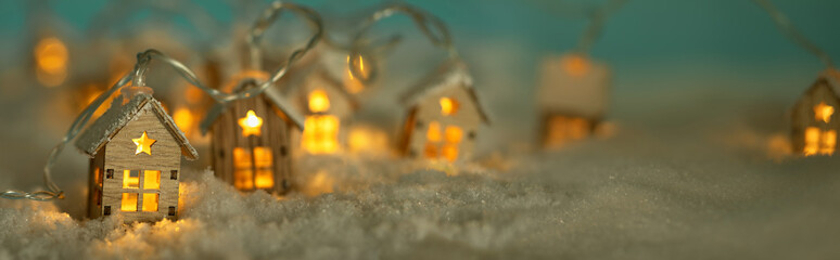 Abstract Christmas Winter Panorama with Wooden Houses Christmas String Lights in Cold Snow...
