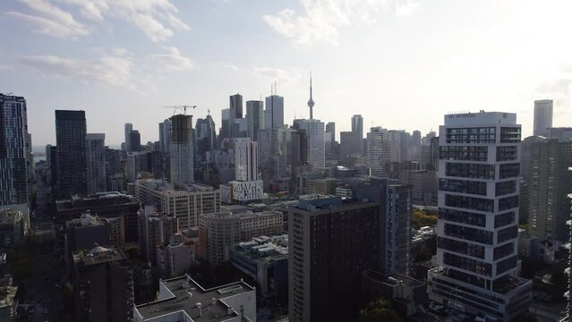 Flying through Toronto's Downtown Core, late afternoon 4K drone. Condominiums, business and residential buildings.
